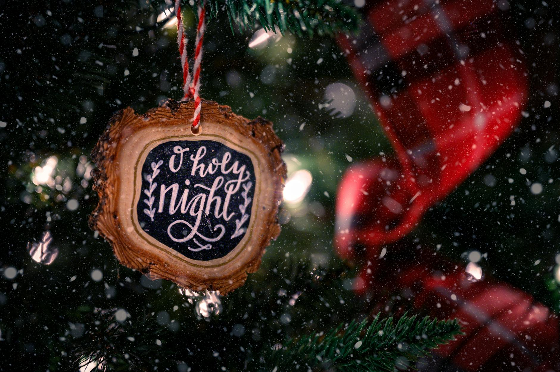 wooden christmas decoration hanging on fir tree