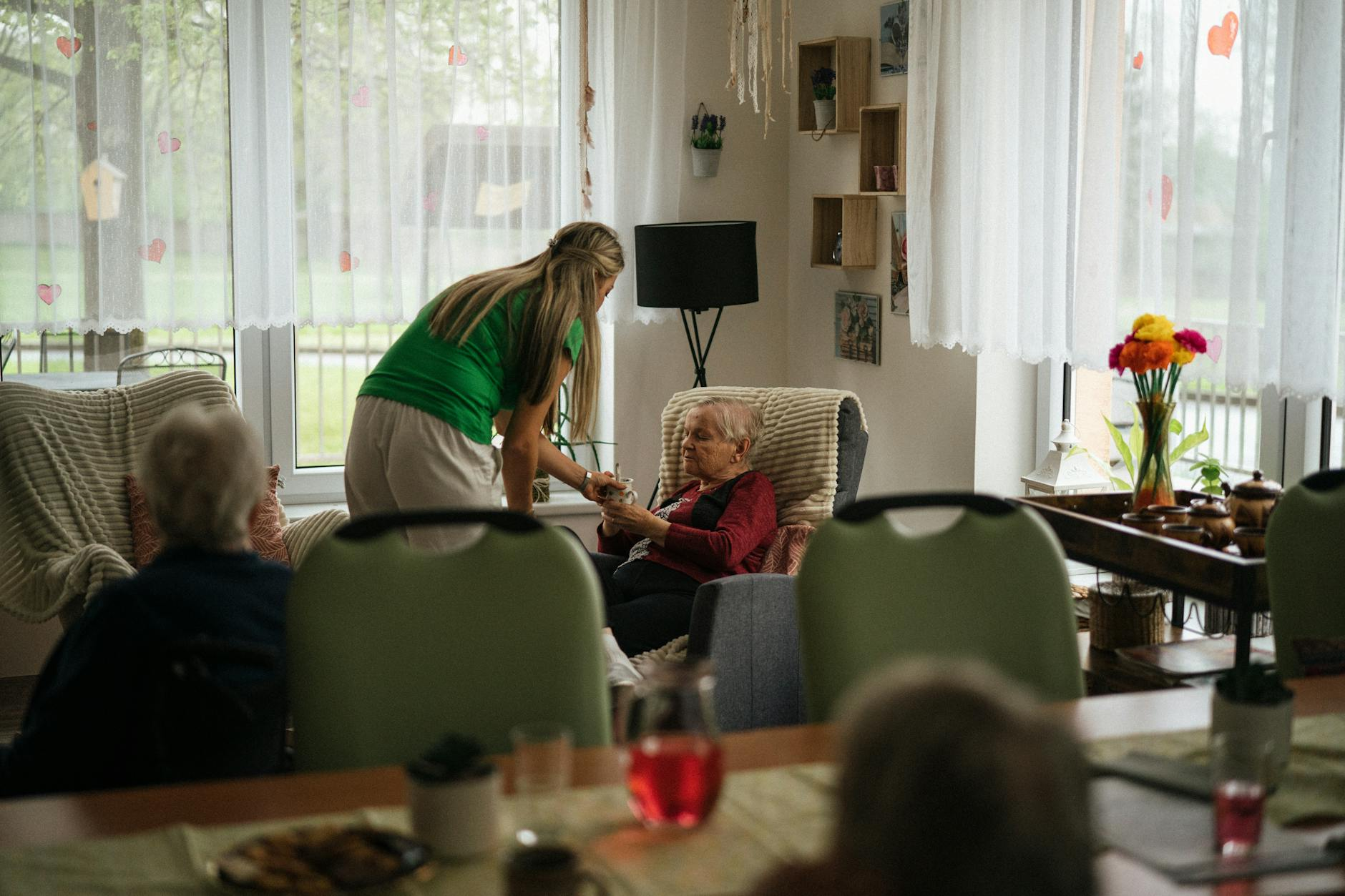 caregiver helping elderly people in nursing home